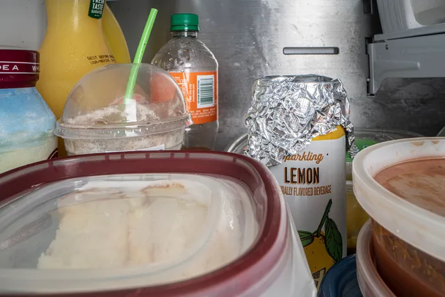 Refrigerator with a mix of poorly stored and placed items for food safety and contributes to food waste; and food that was properly stored in resealable clear containers, on June 8, 2020, in San Antonio, TX. Foil covered can drink, iced coffee in an open container are not good food safety storage pr. Humidity-resistant pantry storage for Houston and Gulf Coast homes